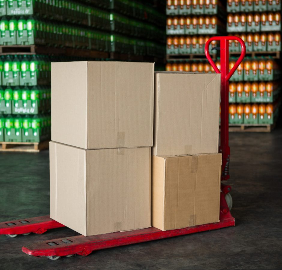 Cardboard boxes on trolley in juice factory
